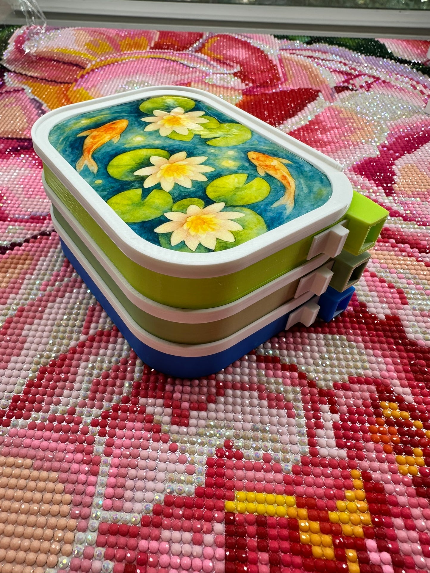 Handmade stackable diamond painting tray with watercolor koi fish design, featuring built-in slider and lid from Artesian Premium collection