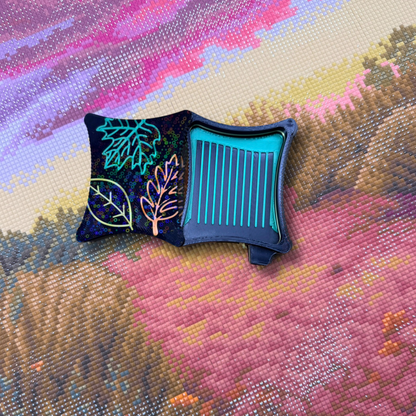 A small ergonomic magnetic diamond art tray from the Autumn Series,  embroidered leaf designs on lid magnetic base on a black tray with green lines.