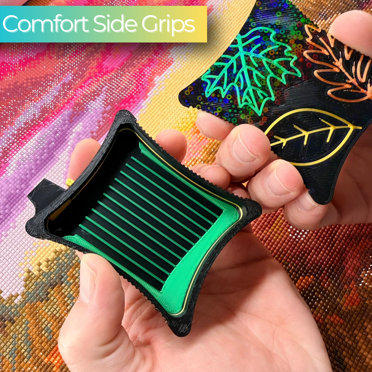 hand holding A small ergonomic magnetic diamond art tray from the Autumn Series,  embroidered leaf designs on lid magnetic base on a black tray with green lines.